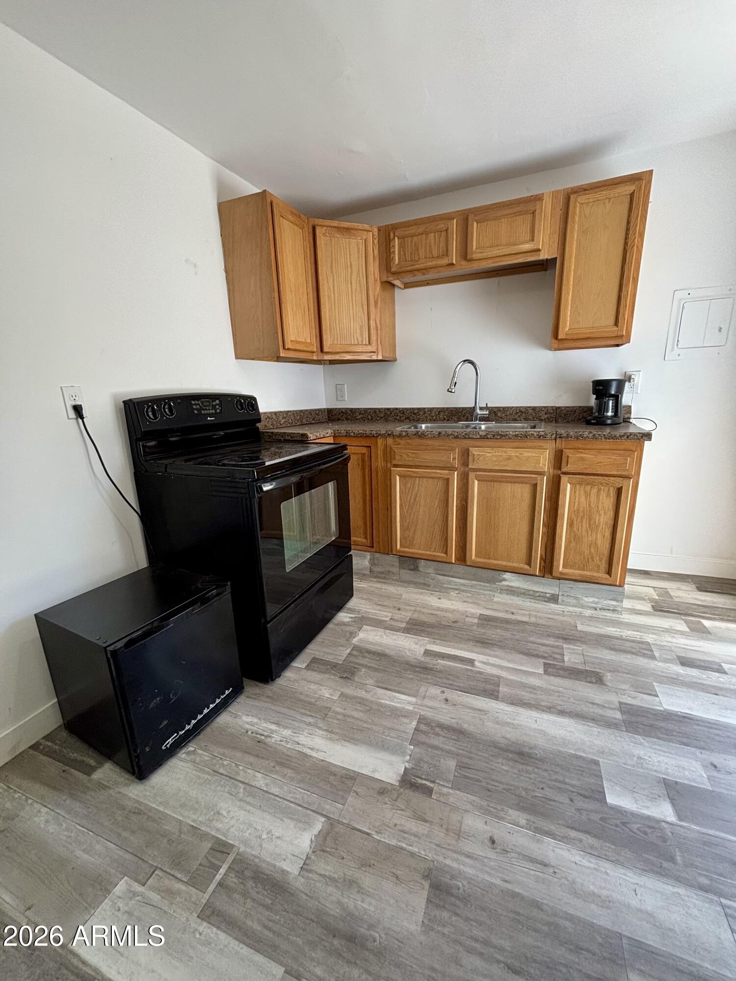 3036 West Almeria Road Phoenix, AZ 85009 - Photo 17 of 20 a kitchen with stainless steel appliances granite countertop a stove and a sink