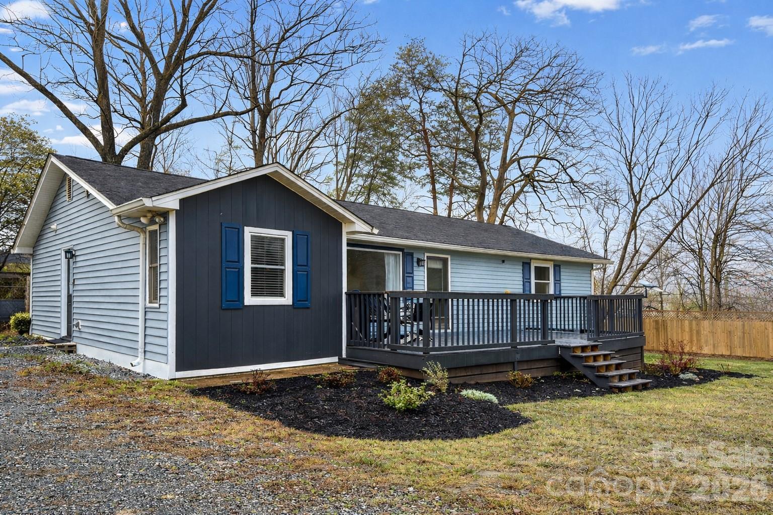 a view of a house with a yard covered in snow