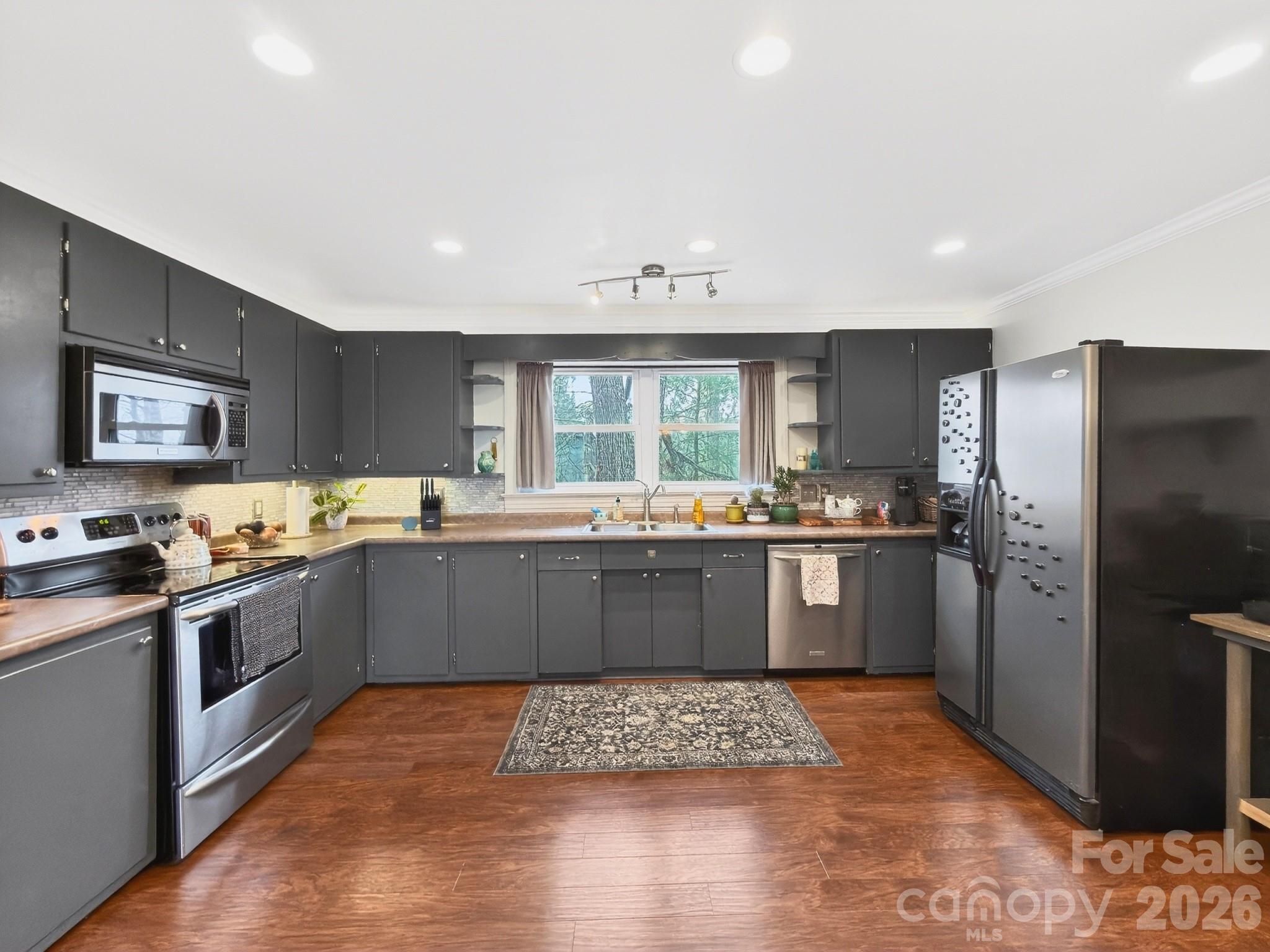 1137 Gilboa Church Road Rutherfordton, NC 28139 - Photo 8 of 21 a kitchen with stainless steel appliances kitchen island granite countertop a refrigerator and stove top oven
