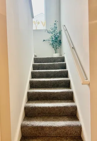 a view of staircase with white walls