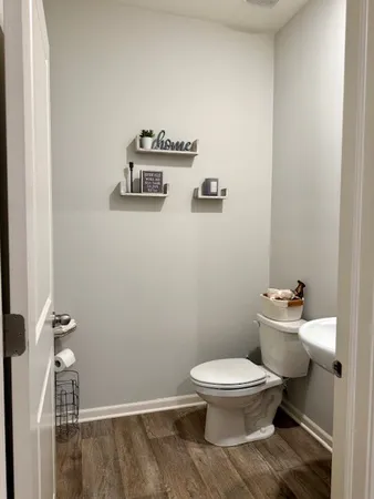 a white toilet sitting next to a bathroom sink
