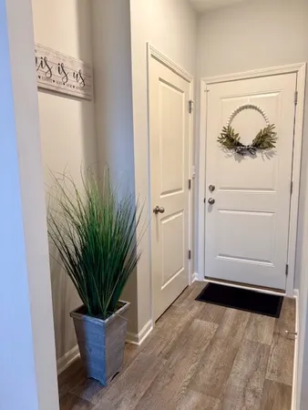 a view of front door with wooden floor