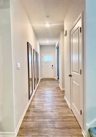 a view of a hallway with wooden floor