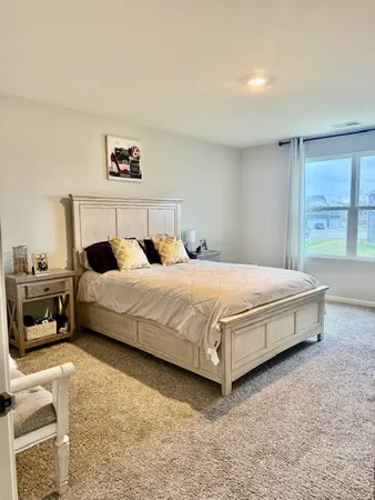 a bedroom with a bed and a couch