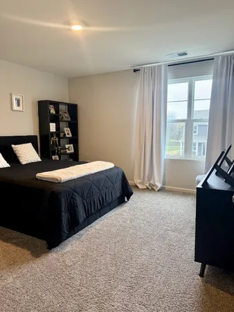 a bedroom with a bed and window