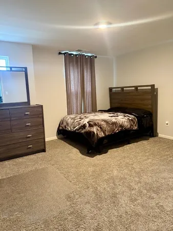 a bedroom with a bed and a dresser