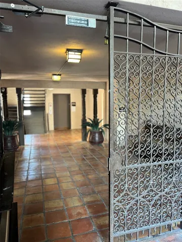 a view of a living room and bathroom with a balcony