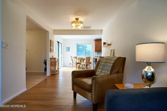 a living room with furniture and a lamp