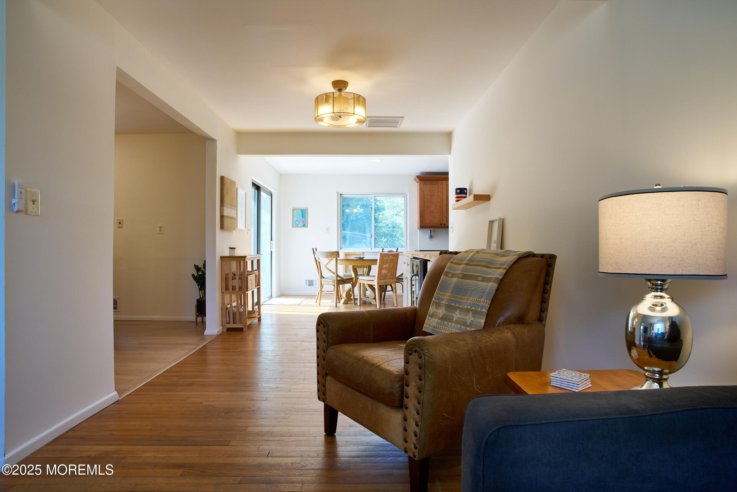 1007 Shore Road Spring Lake Heights, NJ 07762 - Photo 11 of 53 a living room with furniture and a lamp