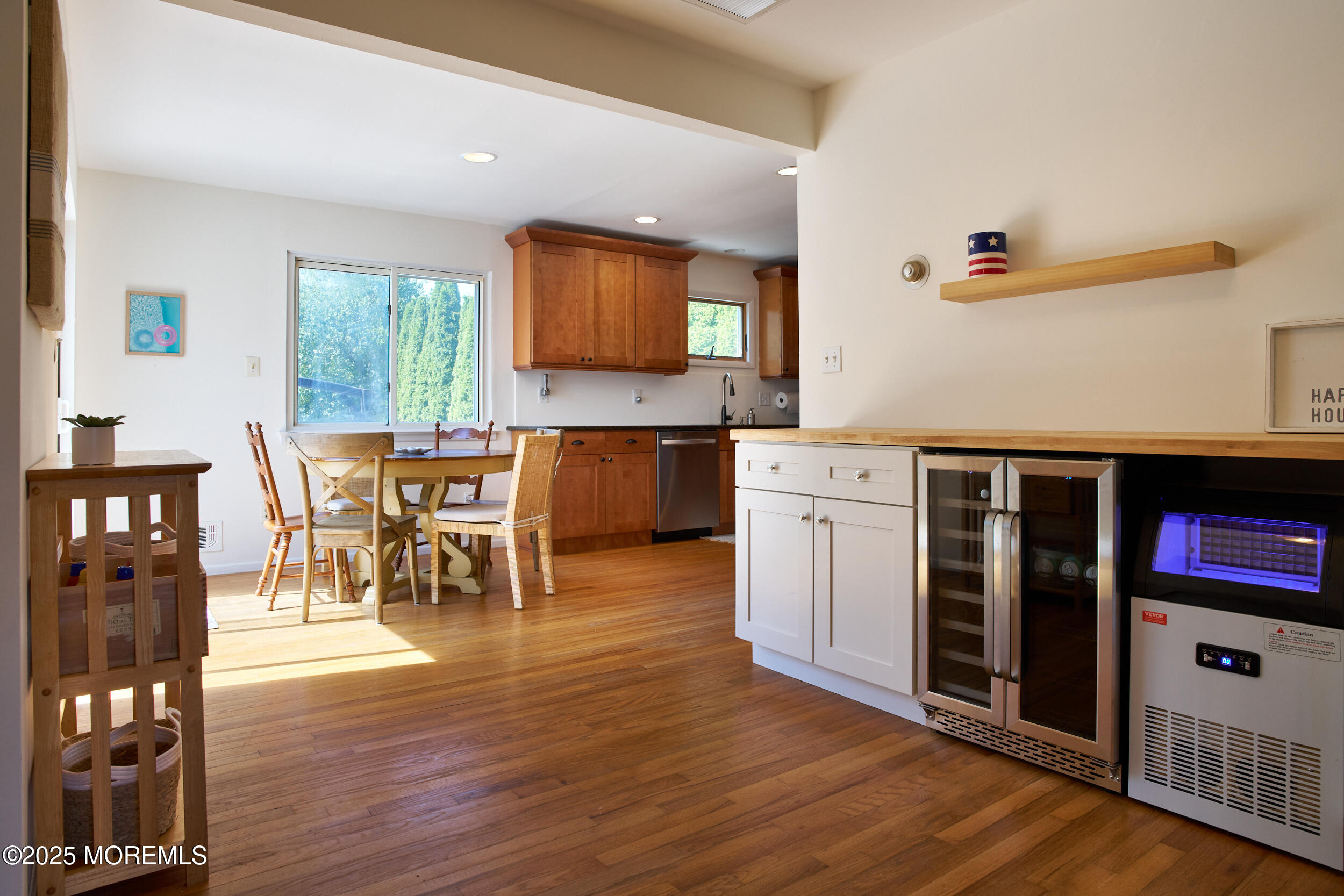 1007 Shore Road Spring Lake Heights, NJ 07762 - Photo 14 of 53 a open kitchen with stainless steel appliances granite countertop a stove top oven a sink a dining table and chairs with wooden floor