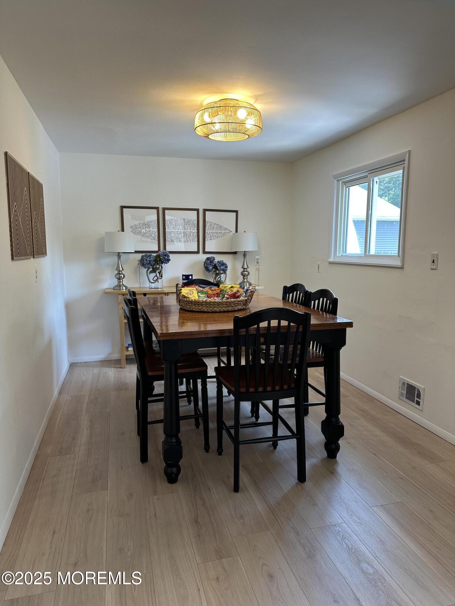 1007 Shore Road Spring Lake Heights, NJ 07762 - Photo 19 of 53 a view of a dining room with furniture and wooden floor