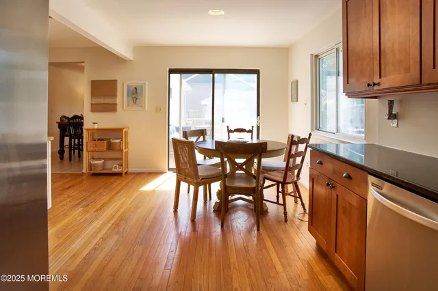 a kitchen with granite countertop stainless steel appliances and wooden cabinets