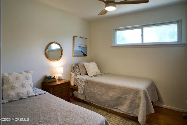a bedroom with a bed and a large mirror