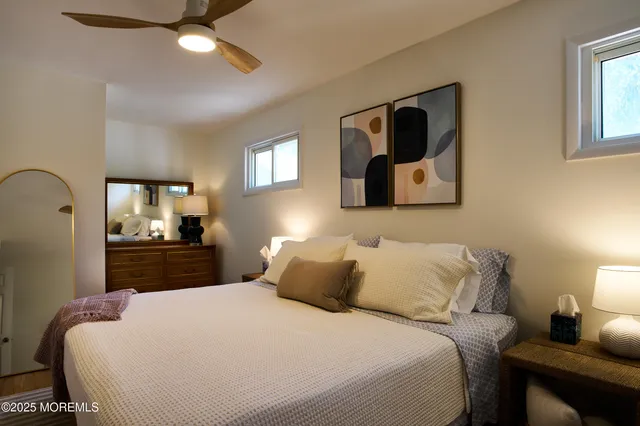 a bedroom with a bed and a large mirror