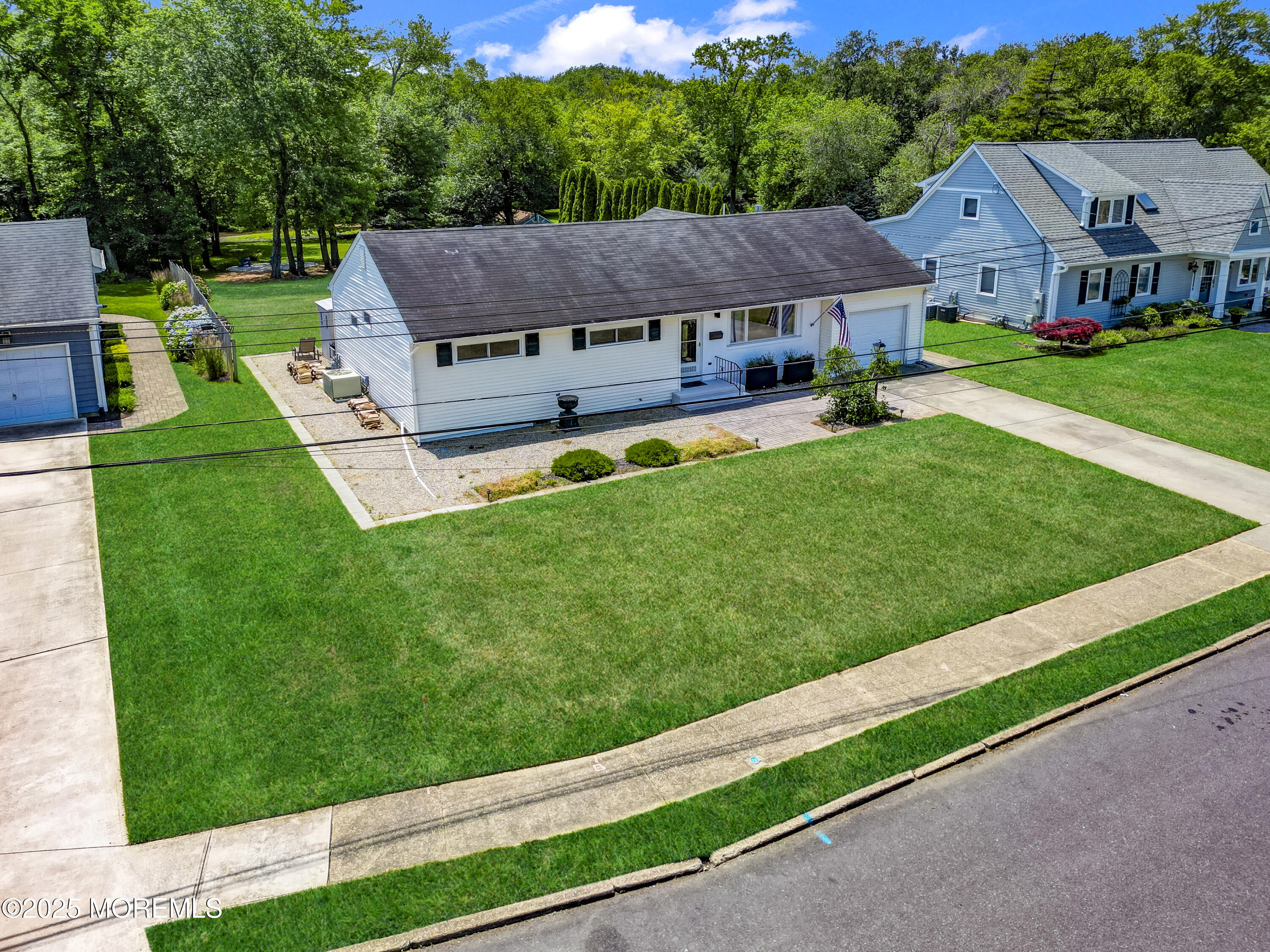 1007 Shore Road Spring Lake Heights, NJ 07762 - Photo 3 of 53 a view of house with garden and tall trees