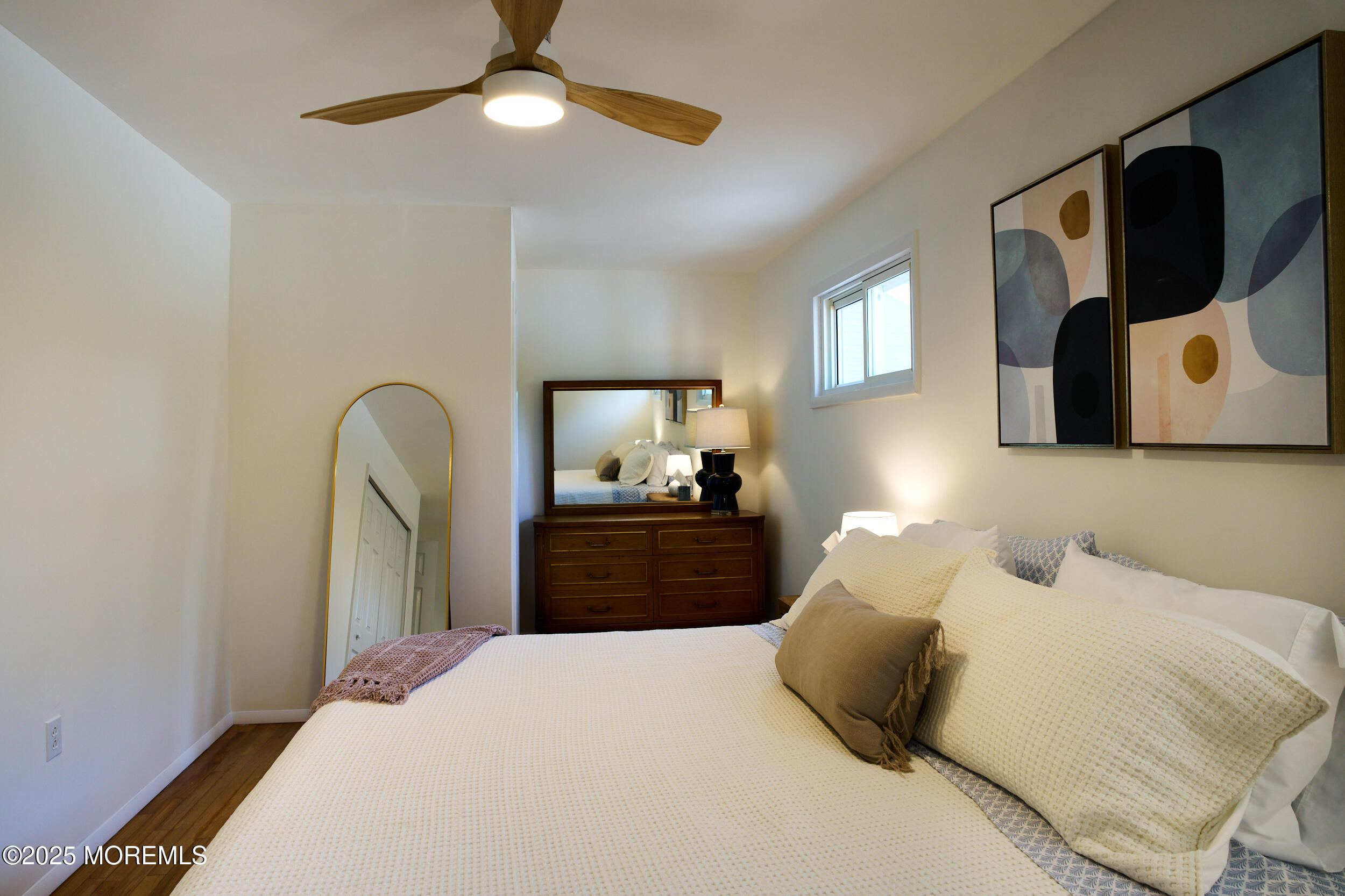 1007 Shore Road Spring Lake Heights, NJ 07762 - Photo 31 of 53 a bedroom with a bed and a chandelier