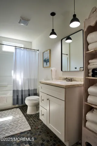 a living room with hardwood floor and window