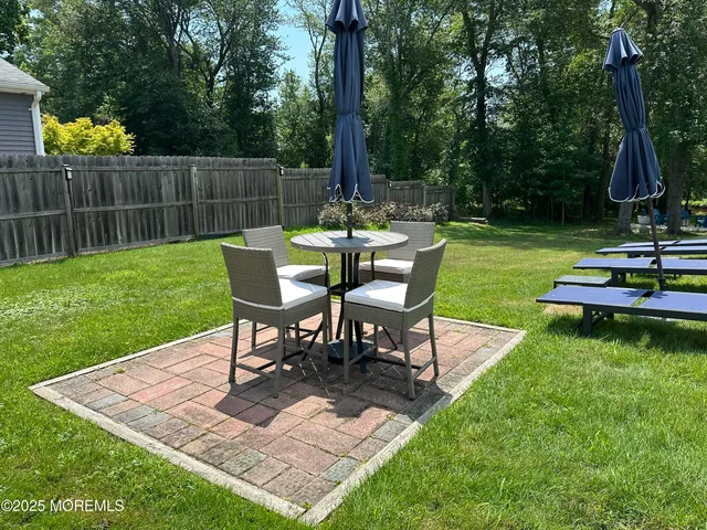 a view of a chairs and table in the garden