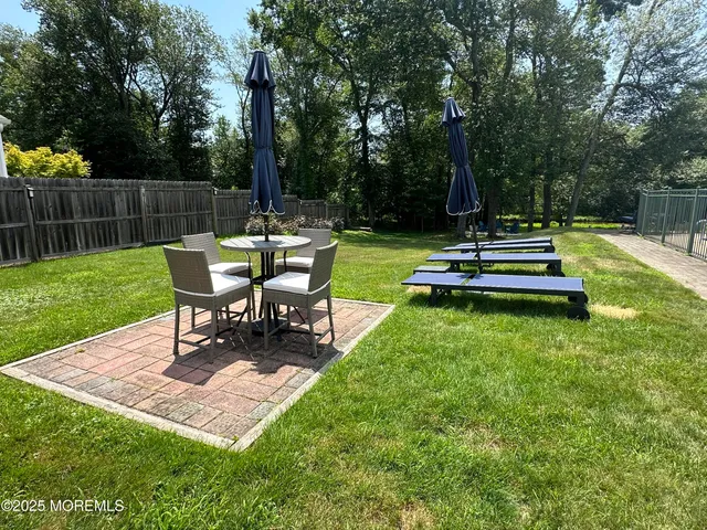 a backyard of a house with table and chairs