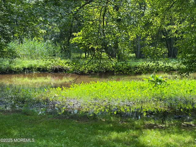 a view of house with backyard