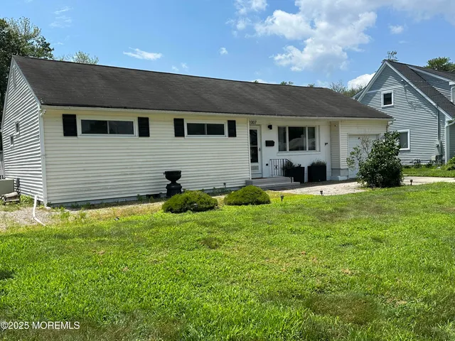 a front view of house with yard and green space