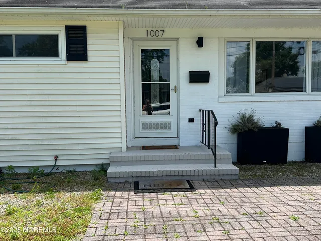 an aerial view of a house with swimming pool a patio and yard