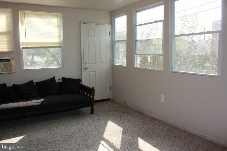10141 Sutherland Road Silver Spring, MD 20901 - Photo 2 of 11 a living room with furniture and a window