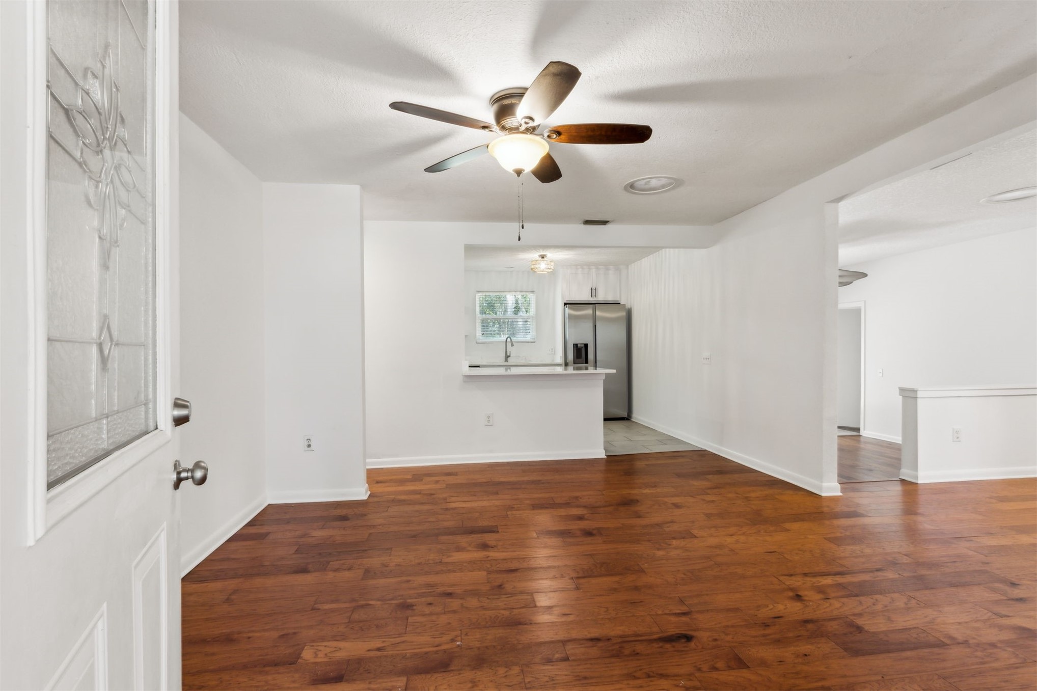 2441 Amelia Road Fernandina Beach, FL 32034 - Photo 4 of 36 an empty room with wooden floor and windows
