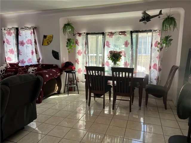 a view of a dining room with furniture and a chandelier