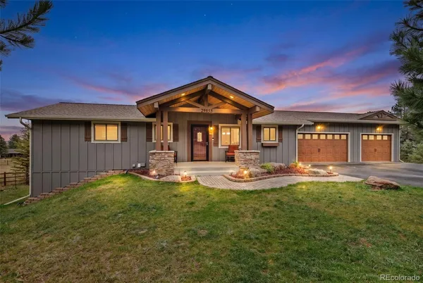 a view of a house with a yard patio and fire pit