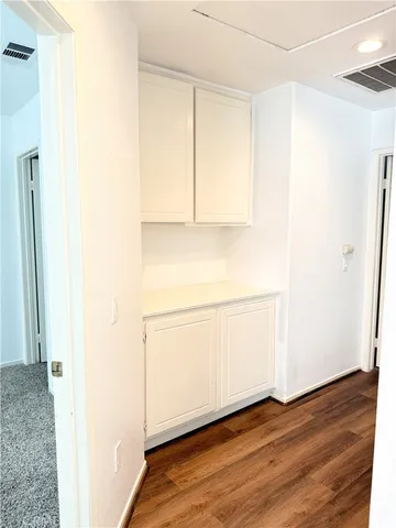 a view of a closet with wooden floor