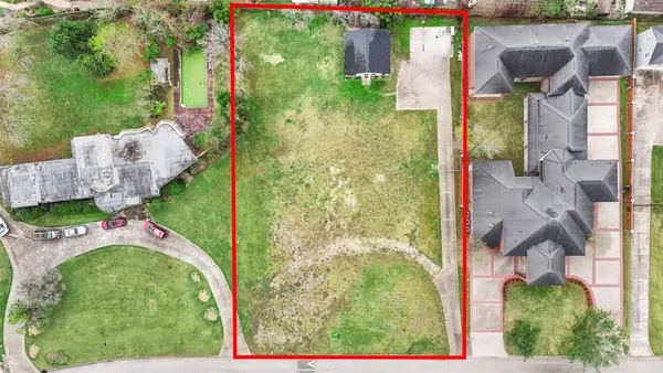 an aerial view of a house with garden space ocean view