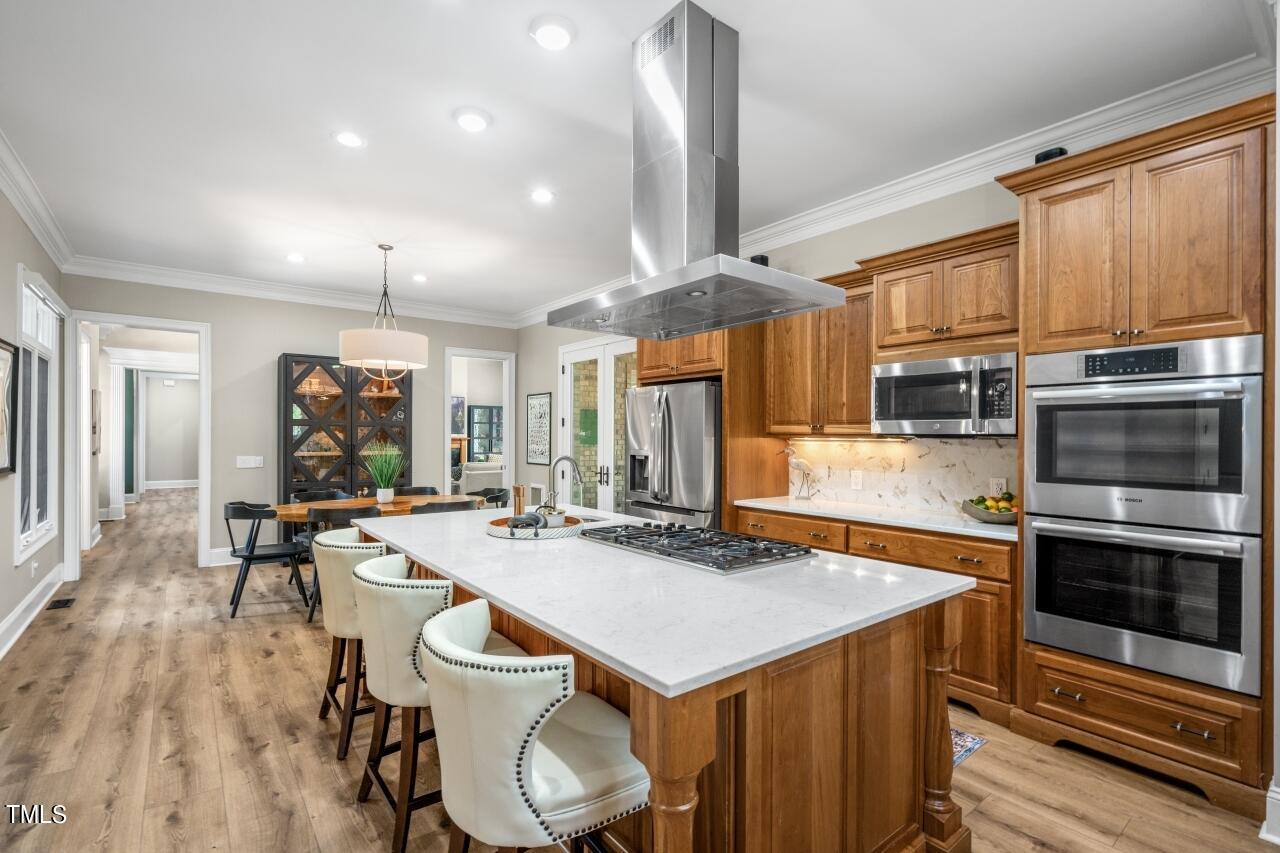 19 Pinewild Drive Pinehurst, NC 28374 - Photo 11 of 44 a kitchen with a table chairs microwave and cabinets