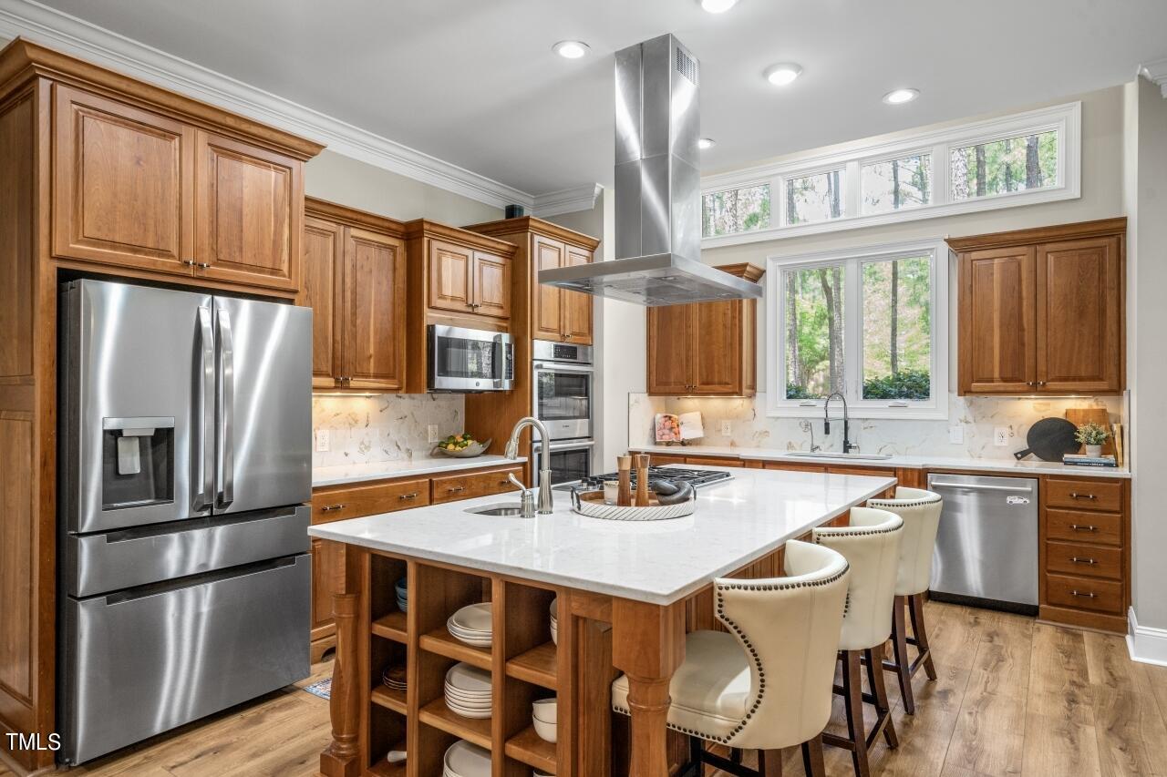 19 Pinewild Drive Pinehurst, NC 28374 - Photo 12 of 44 a kitchen with stainless steel appliances a dining table chairs refrigerator and cabinets