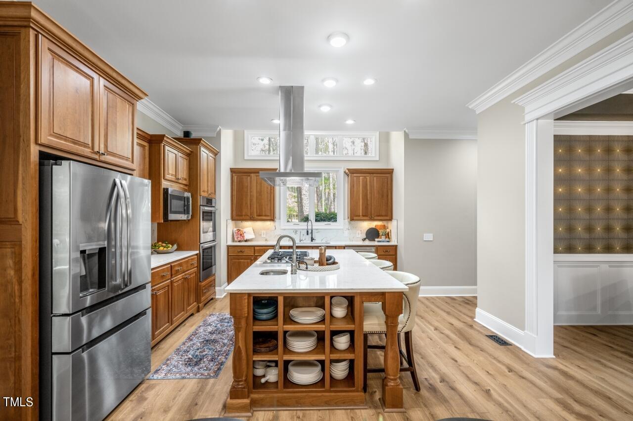19 Pinewild Drive Pinehurst, NC 28374 - Photo 13 of 44 a kitchen with stainless steel appliances a stove a refrigerator and a dining table