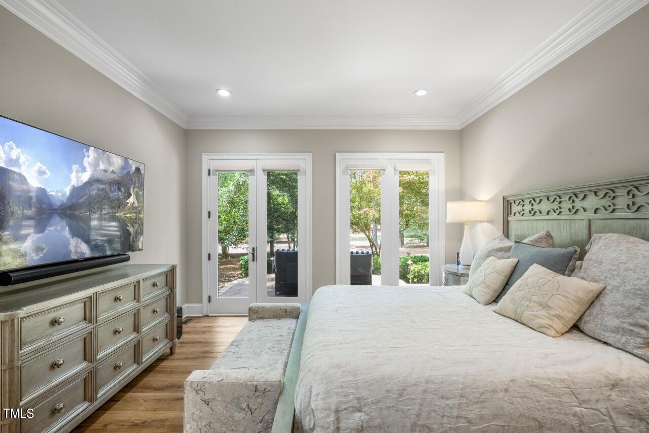 19 Pinewild Drive Pinehurst, NC 28374 - Photo 19 of 44 a bedroom with a bed and a flat screen tv