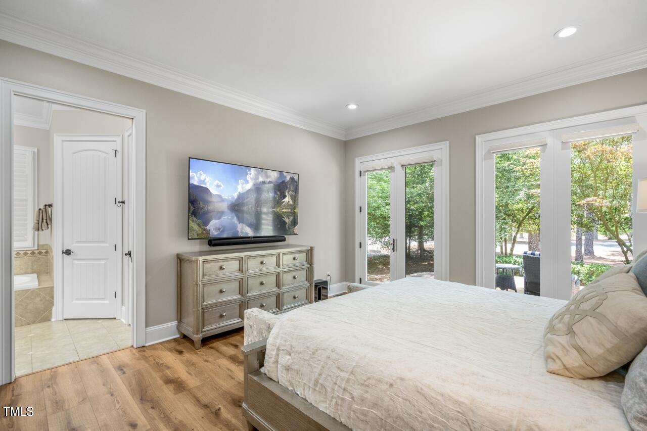 19 Pinewild Drive Pinehurst, NC 28374 - Photo 20 of 44 a bedroom with a bed and a flat screen tv