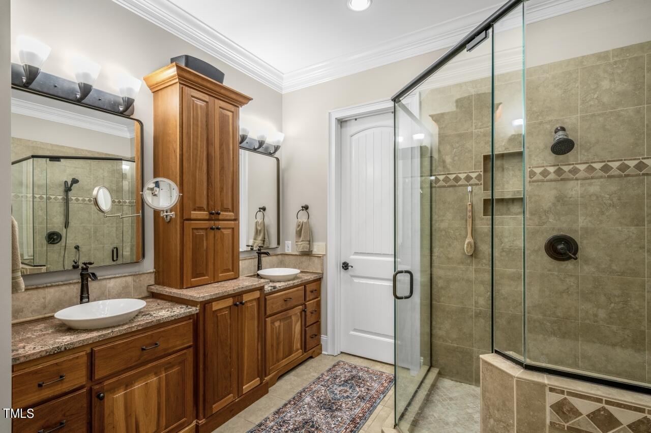 19 Pinewild Drive Pinehurst, NC 28374 - Photo 22 of 44 a bathroom with a double vanity sink mirror double and shower