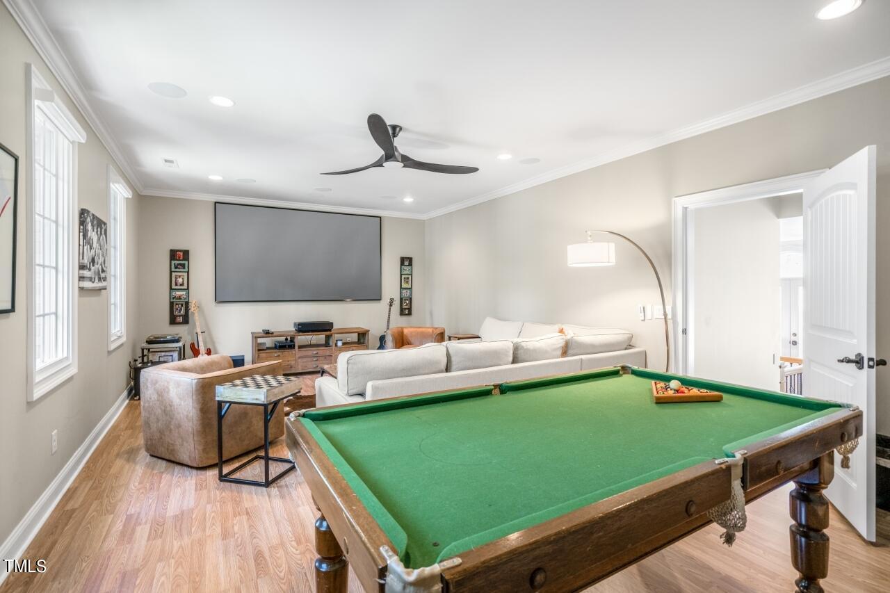 19 Pinewild Drive Pinehurst, NC 28374 - Photo 28 of 44 a living room with green floor furniture and a wooden floor
