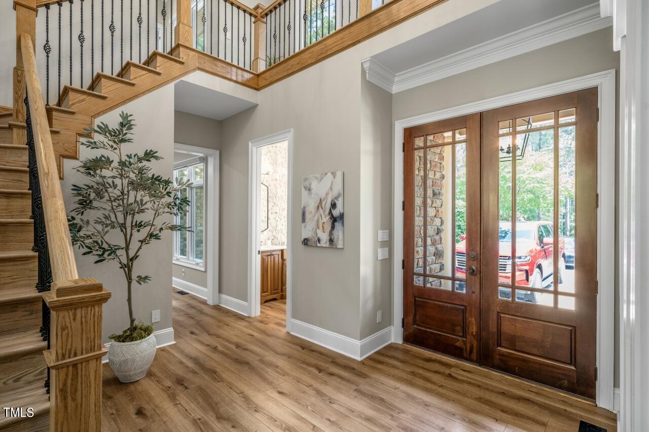 19 Pinewild Drive Pinehurst, NC 28374 - Photo 3 of 44 a view of a hallway with wooden floor and furniture