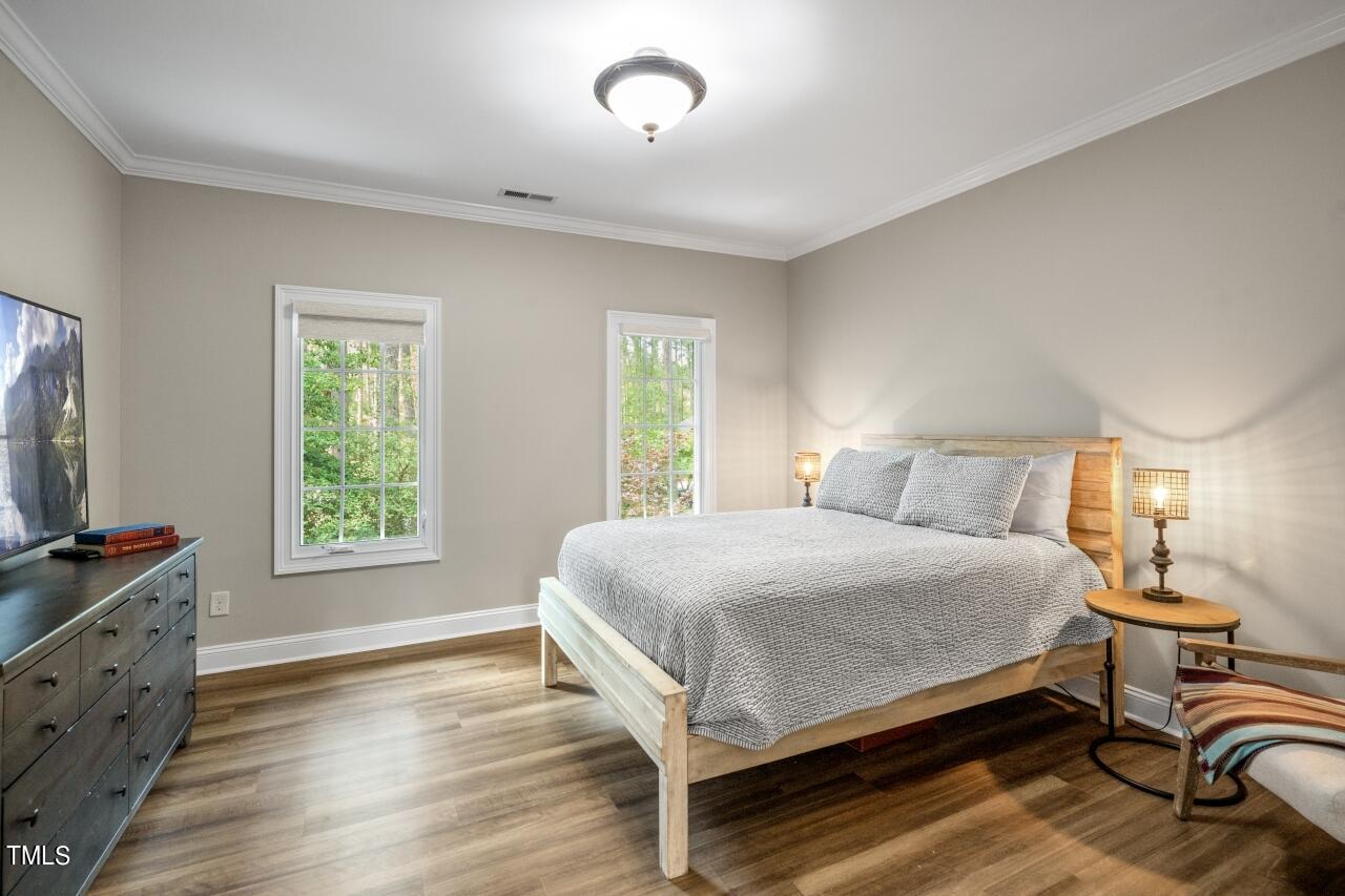 19 Pinewild Drive Pinehurst, NC 28374 - Photo 31 of 44 a bedroom with a bed and a flat tv screen on dresser