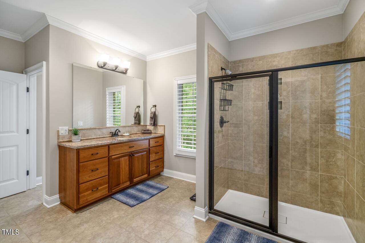 19 Pinewild Drive Pinehurst, NC 28374 - Photo 32 of 44 a bathroom with a granite countertop sink mirror and a shower