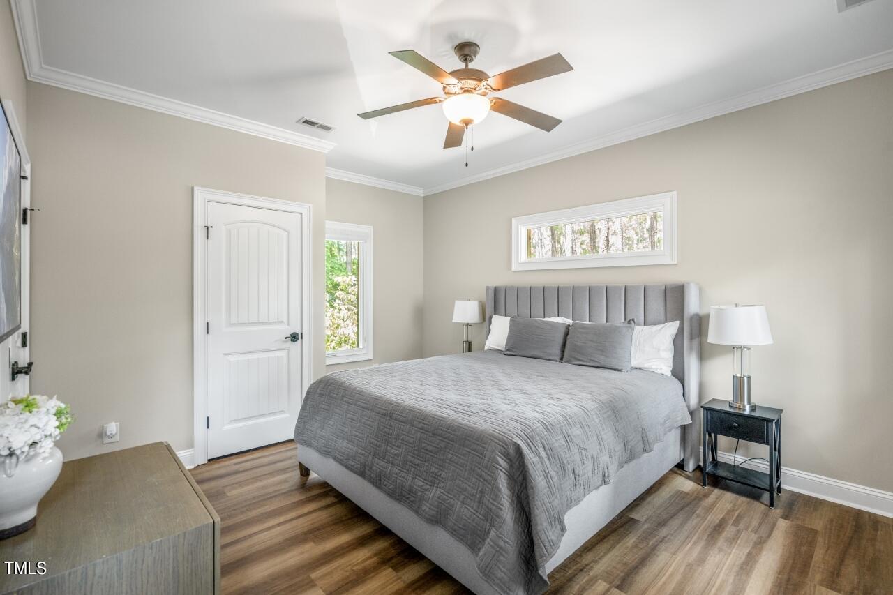 19 Pinewild Drive Pinehurst, NC 28374 - Photo 33 of 44 a bedroom with a bed and a chandelier