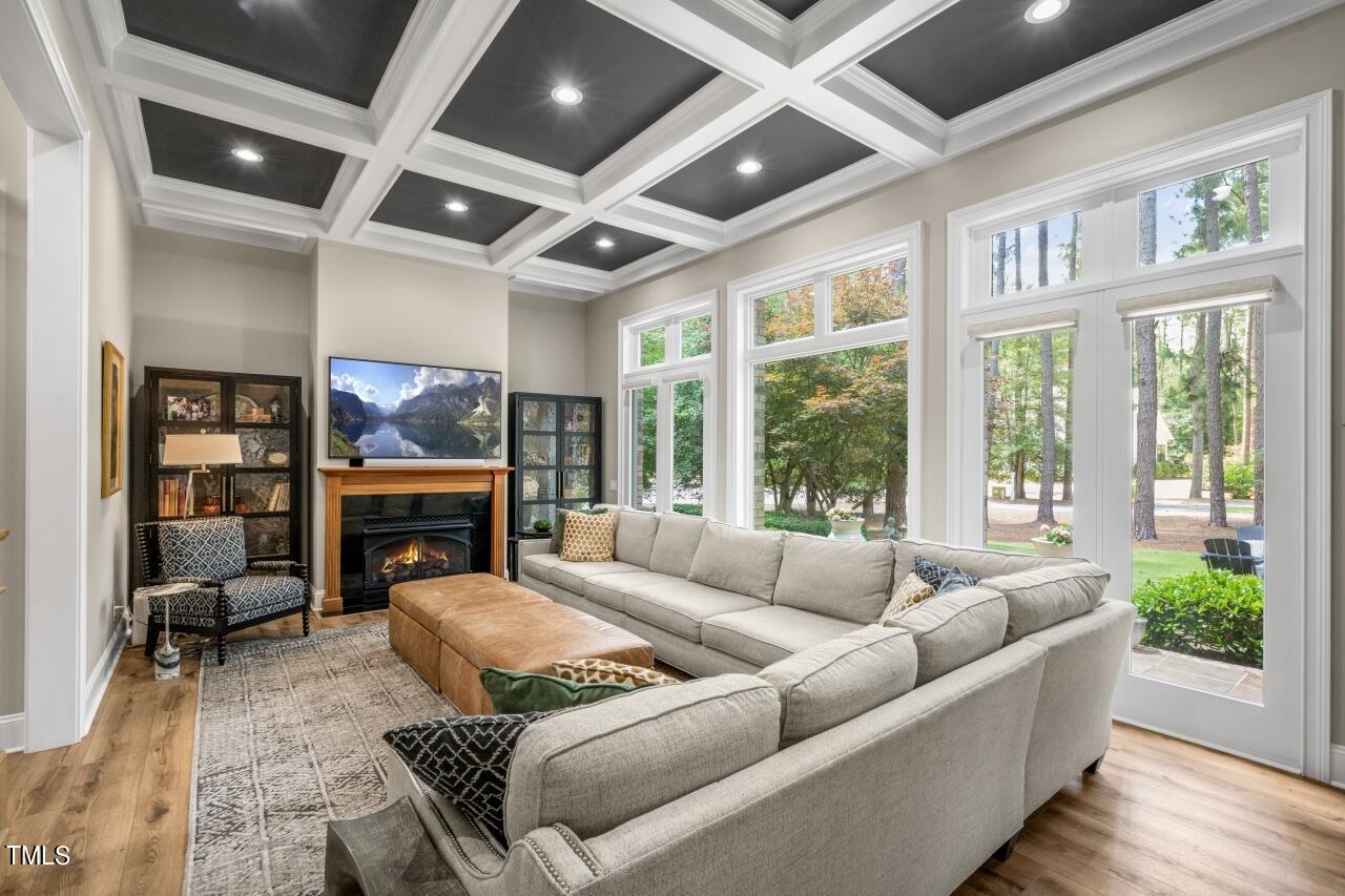 19 Pinewild Drive Pinehurst, NC 28374 - Photo 5 of 44 a living room with furniture large windows and a fireplace