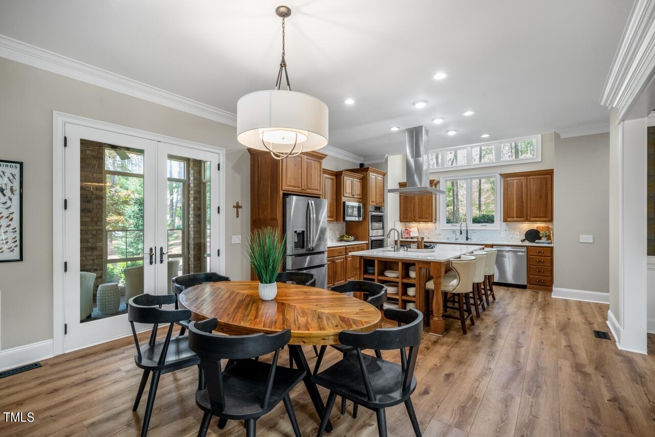 19 Pinewild Drive Pinehurst, NC 28374 - Photo 9 of 44 a view of a dining room and livingroom with furniture wooden floor a chandelier