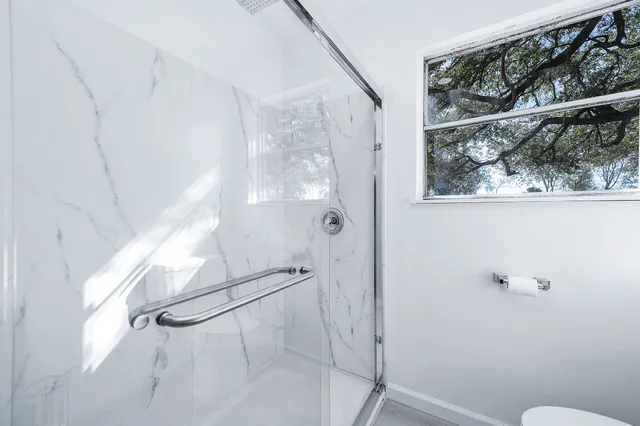 a bathroom with a glass shower door