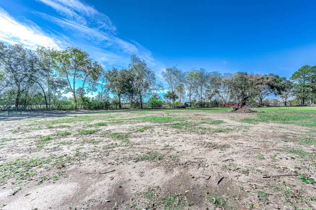 a view of a field with trees in the background