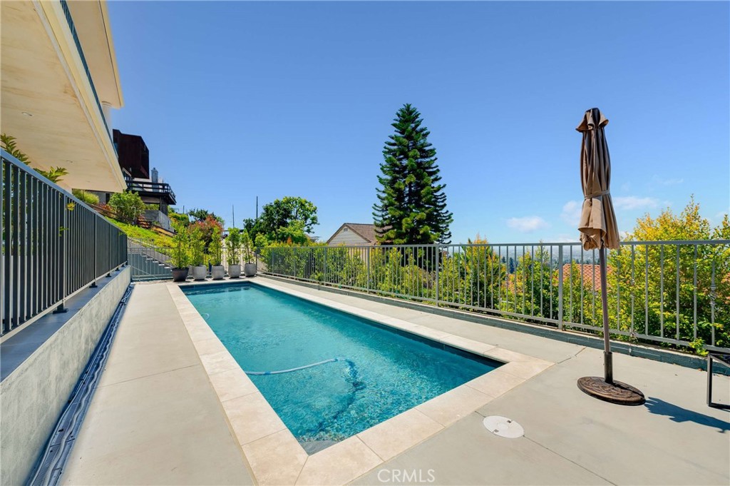 11837 Rideout Way Whittier, CA 90601 - Photo 37 of 44 a view of a swimming pool with a patio and plants