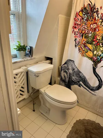 a bathroom with a granite countertop sink and a blue curtain