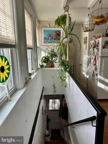 a kitchen with stainless steel appliances granite countertop a refrigerator a stove a sink and a microwave with wooden floor